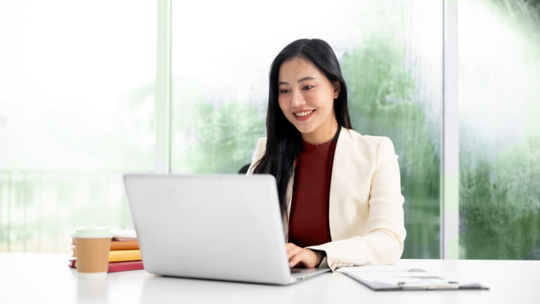Smiling,Asian,Businesswoman,Or,Office,Worker,In,Suit,Looking,And
